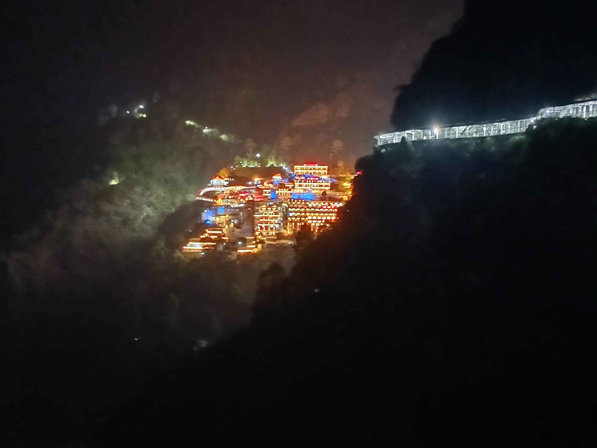 The Vaishno Devi temple complex lit on the mountainside at night